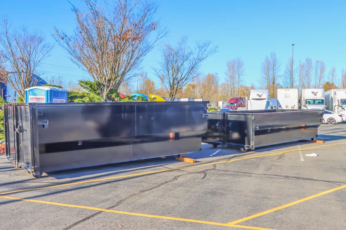 Professional dumpster rental service with roll-off container on residential driveway in Kettering